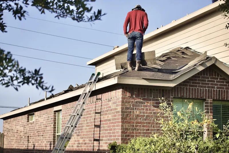 Professional roofer working on a residential roof in Shoreland